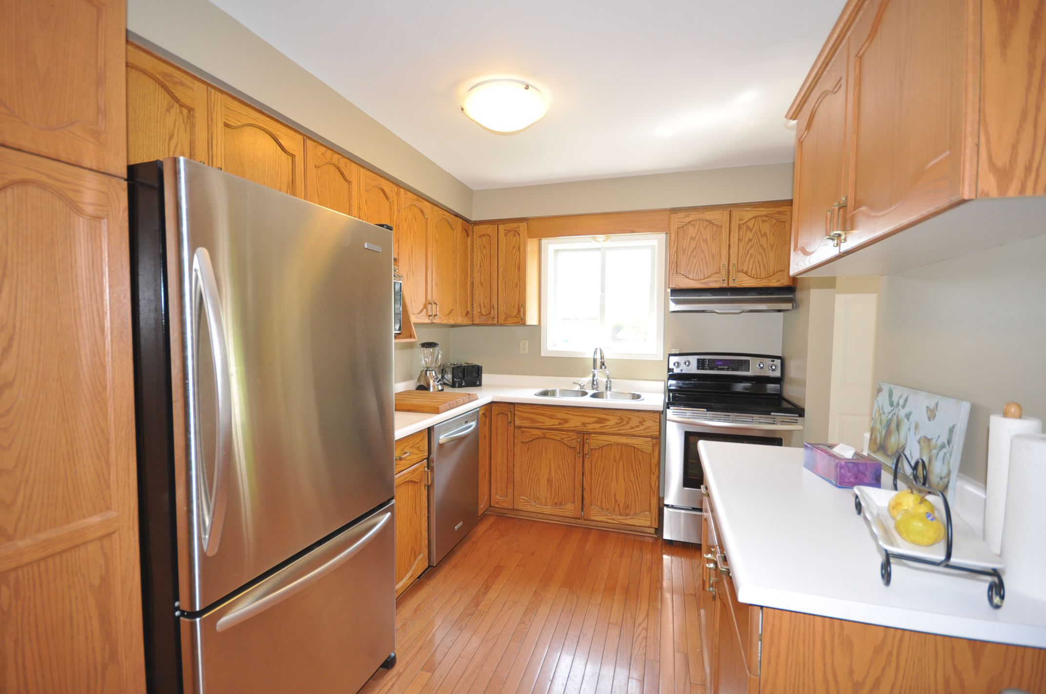 Eat in kitchen with hardwood flooring, pantry & an extra set of cupboards