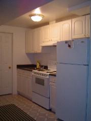 The lower level also has a full kitchen with white cabinetry and 3 piece bath 