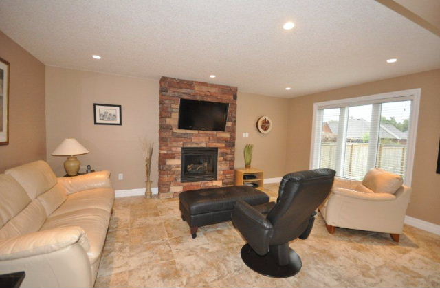Open concept Great Room with gorgeous one of a kind stone fireplace.  