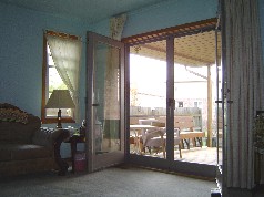 Newer double doors leading to the covered deck off the master bedroom 