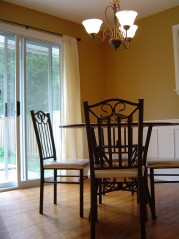 Formal dining room with hardwood floors and newer sliding doors to the private backyard 
