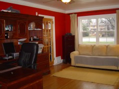 Spacious Living room with french door, hardwood flooring plus 2 sets of sunny windows 