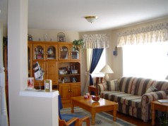 The main floor family room with large sunny bay window is open to the kitchen 