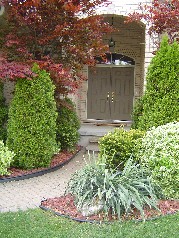 Gorgeous perennial garden leading to the double front doors 