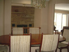 Dining room overlooks family room with floor to ceiling fireplace