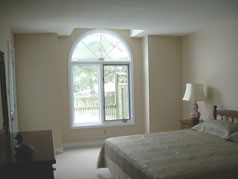 Master bedroom with large window and door to sundeck